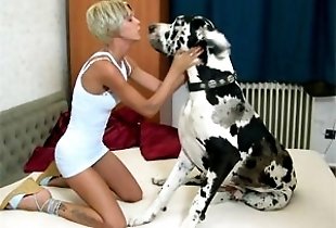 Slender babe kissing a huge dog